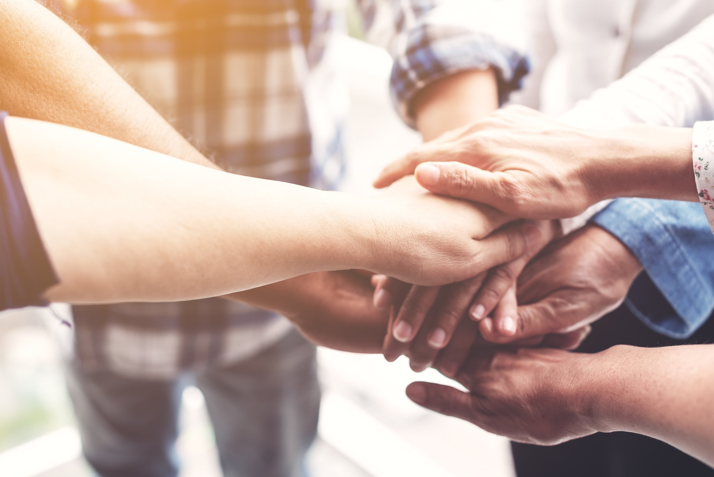 People hand assemble as a connection meeting teamwork concept. Group of people colleague assembly hands as a business or work achievement. Man and women touch each other hands. Teamwork conceptual.